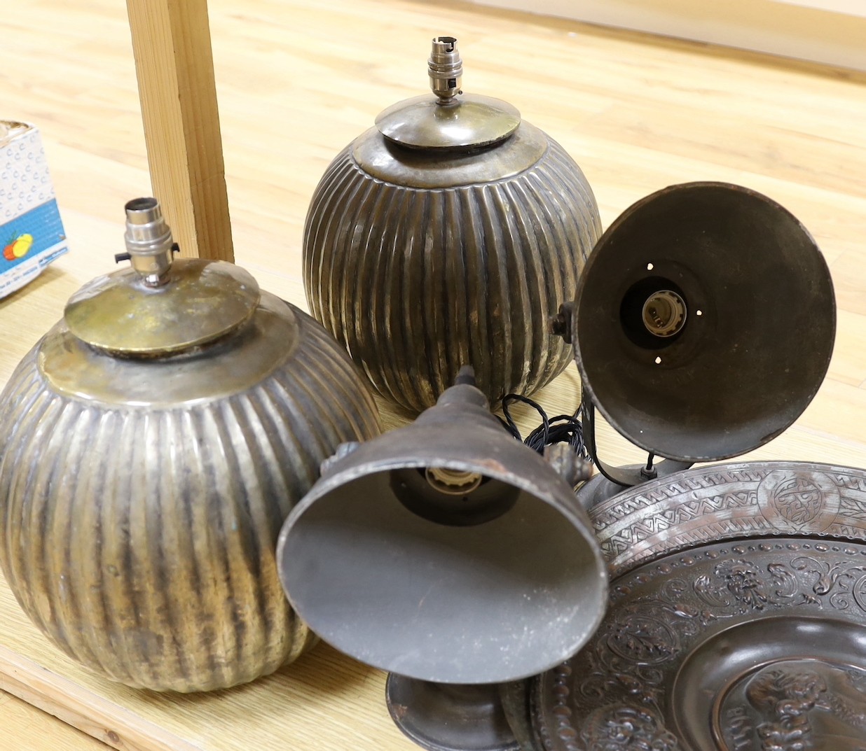 Two pairs of lamps and three metalwork chargers, largest charger 46 cms diameter